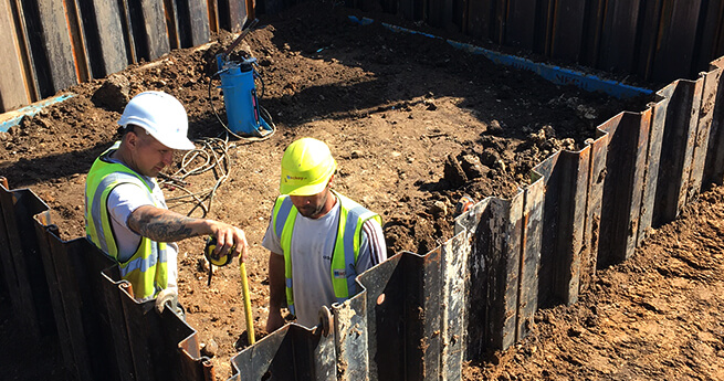 Mackoy Groundworks and Civil Engineering Operatives Measuring on Site